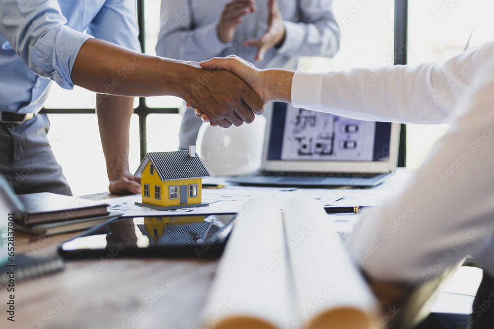 Collaboration of engineers, architects and contractors. Architects hand in hand promote teamwork cooperation of colleagues in construction projects.