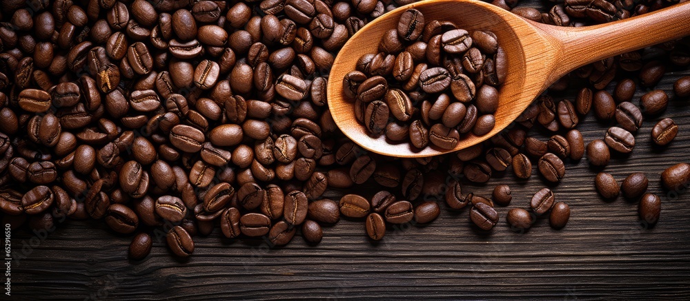 Blend of dark roasted coffee beans on wooden surface