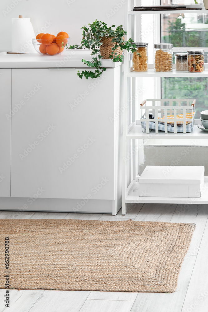 Wicker rug on floor in light kitchen