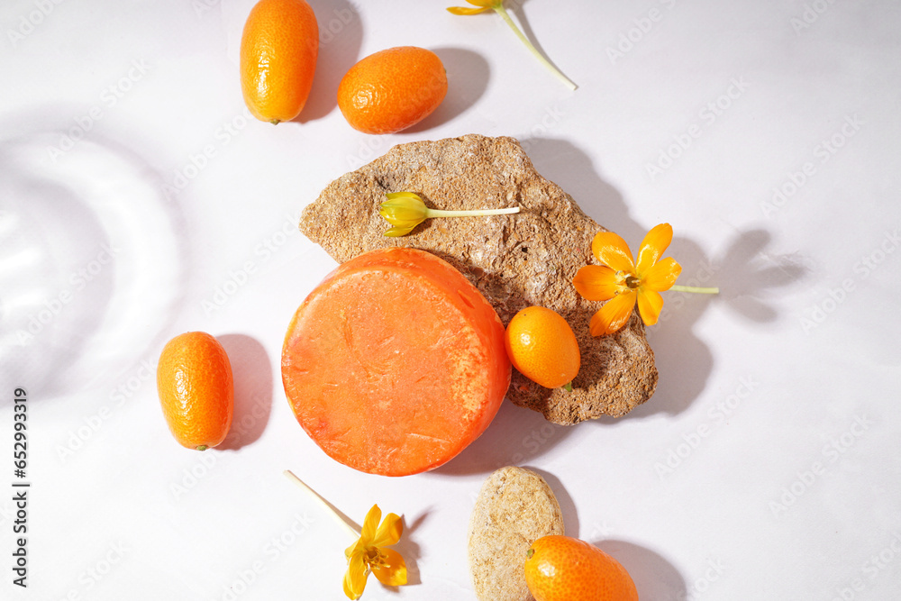 Handmade solid shampoo, flowers and kumquats on light background