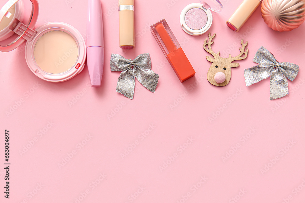 Composition with decorative cosmetics and Christmas decor on pink background