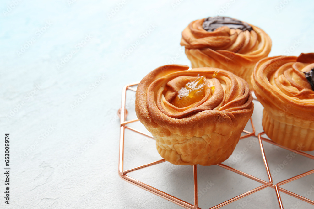 Grid of tasty cruffins with jam on white background