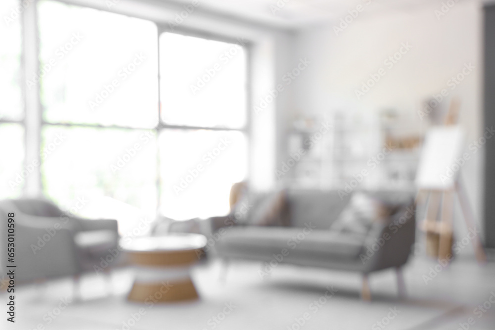 Blurred view of living room with sofa and armchair