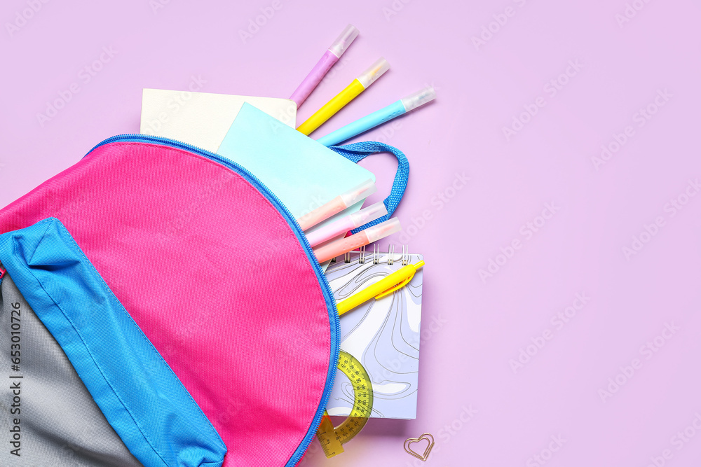 Stylish school backpack with different stationery on lilac background