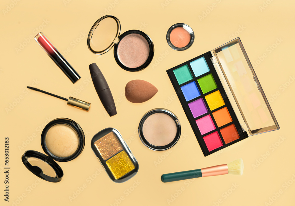 Different decorative cosmetics on yellow background