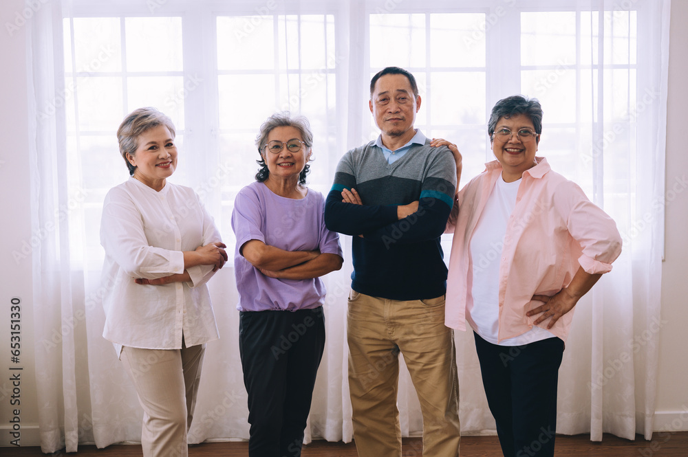 A group of elderly people stand together before exercising for their health.