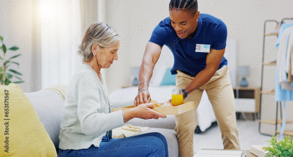 Breakfast, assisted living and retirement with a old woman on a sofa in the living room of her home. Morning, food and a nurse black man serving a meal to an elderly patient in a care facility