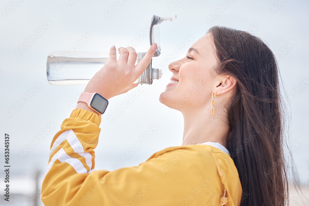 Happy woman, drinking water and outdoor with bottle to relax, rest and detox body in training, exercise or running. Drink, liquid and healthy hydration in summer morning with athlete and self care