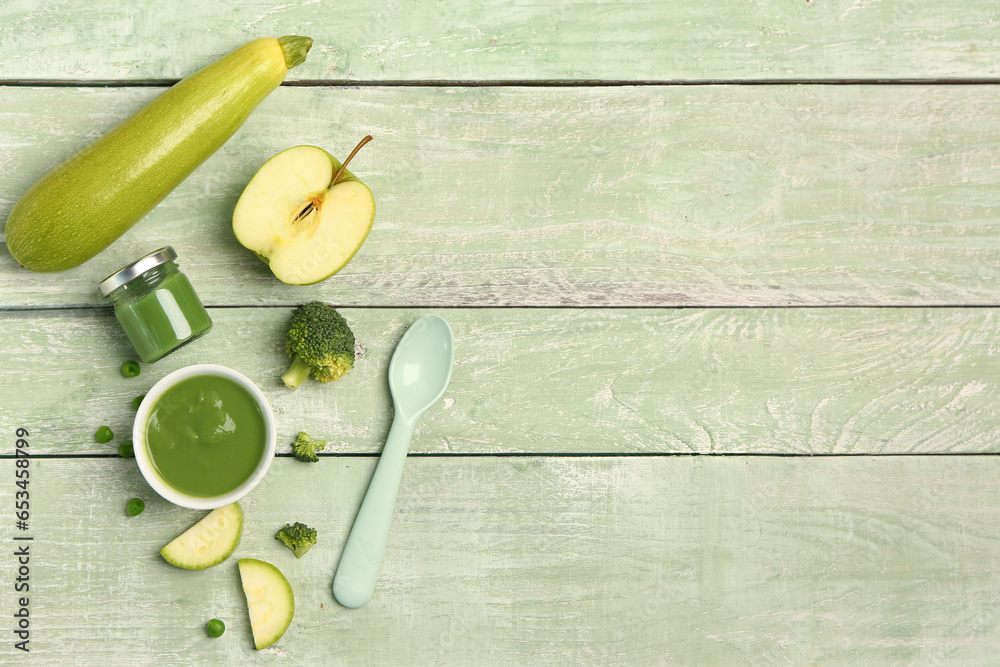 Composition with healthy baby puree and ingredients on color wooden background