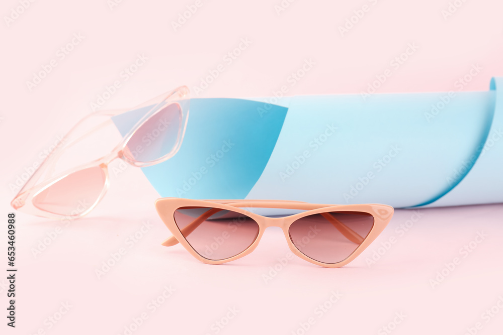 Stylish sunglasses on color background