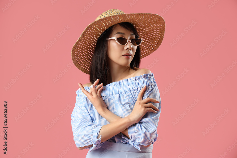 Beautiful Asian woman in stylish sunglasses on pink background