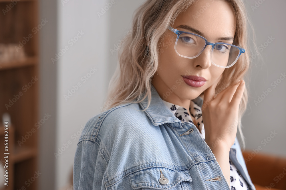 Young woman in stylish eyeglasses at home, closeup