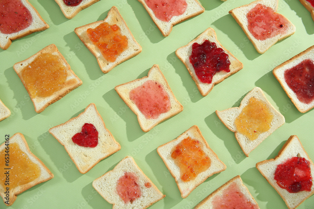 Many toasts with different jams on green background