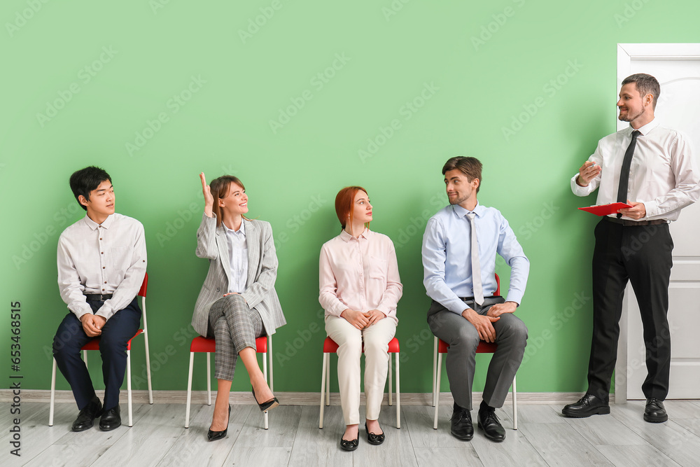 Human resources manager with applicants in room