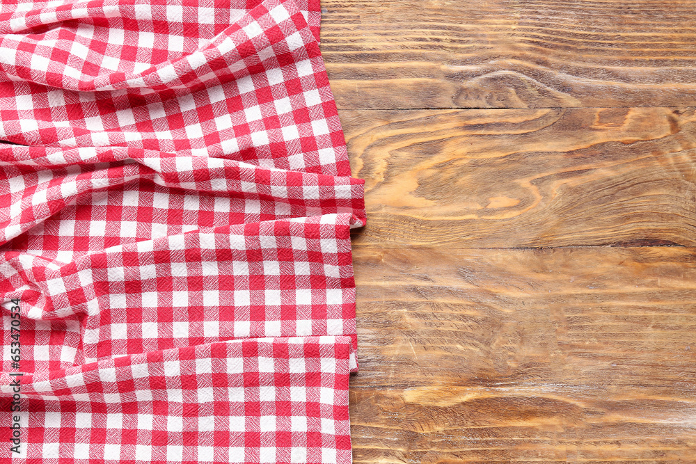 Crumpled red napkin on wooden background