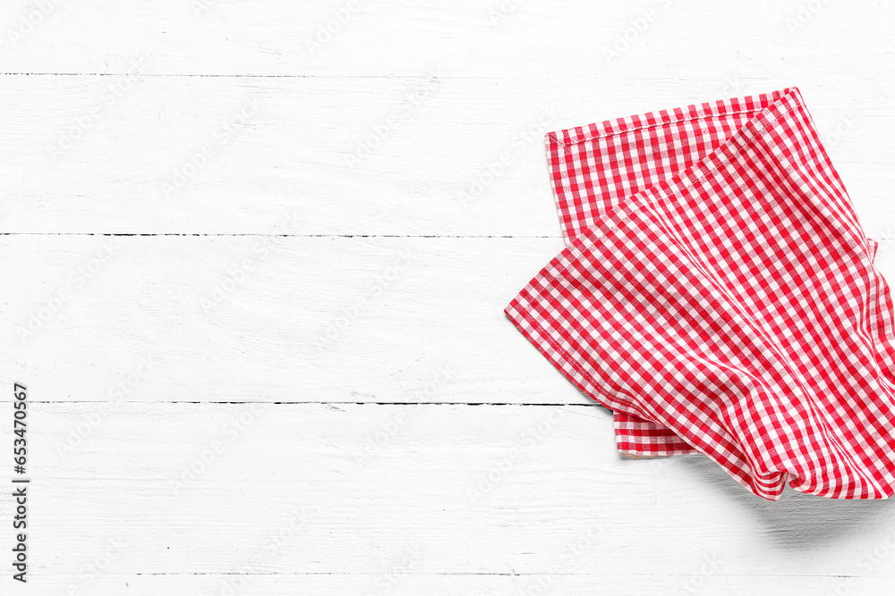 Red checkered napkin on light wooden background