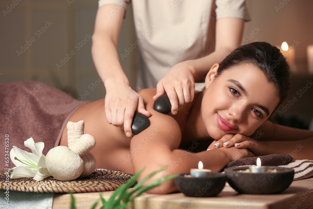 Beautiful woman receiving spa massage in salon