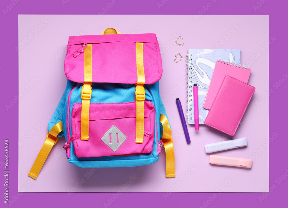 Stylish school backpack with different stationery on color background