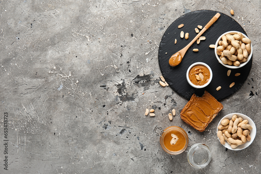 Toast with peanut butter and nuts on grey background