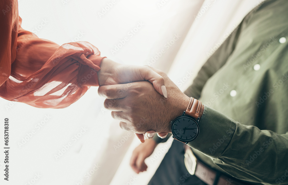 Business people, handshake and partnership in meeting, b2b deal or teamwork below at office. Low angle of man and woman shaking hands for startup, introduction or thank you in agreement at workplace