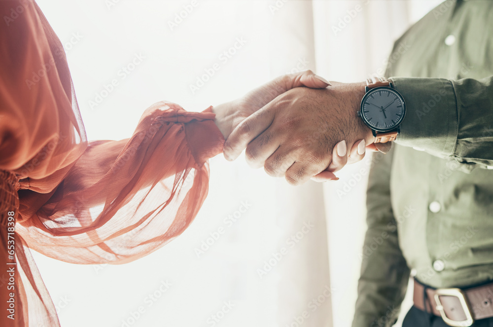 Creative people, handshake and teamwork in meeting, b2b deal or partnership together at office. Closeup of man and woman shaking hands for startup, introduction or thank you in agreement at workplace