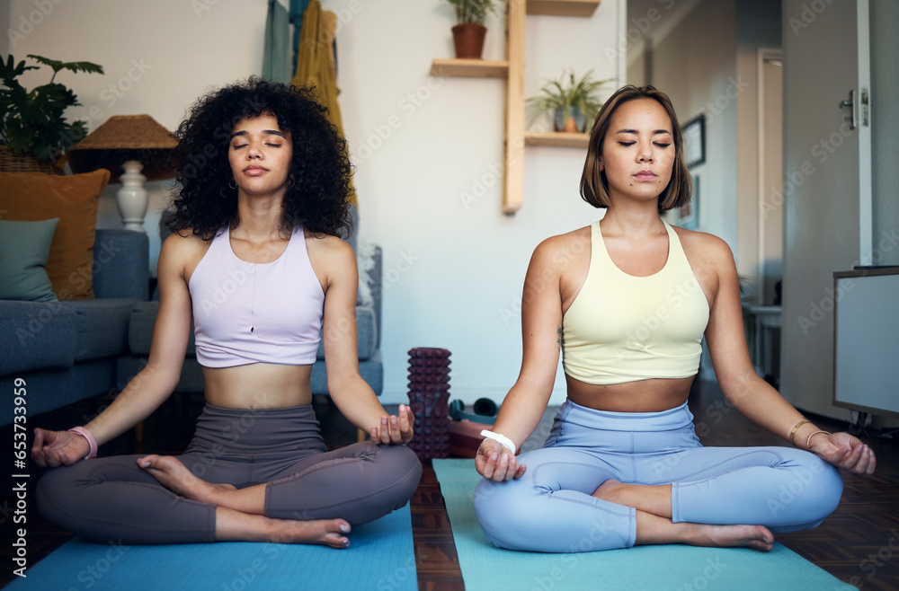 Women, friends and yoga in home for wellness, workout or exercise while sitting for peace, calm or zen. Female, people and meditation for bond, together or health for fitness on floor in living room