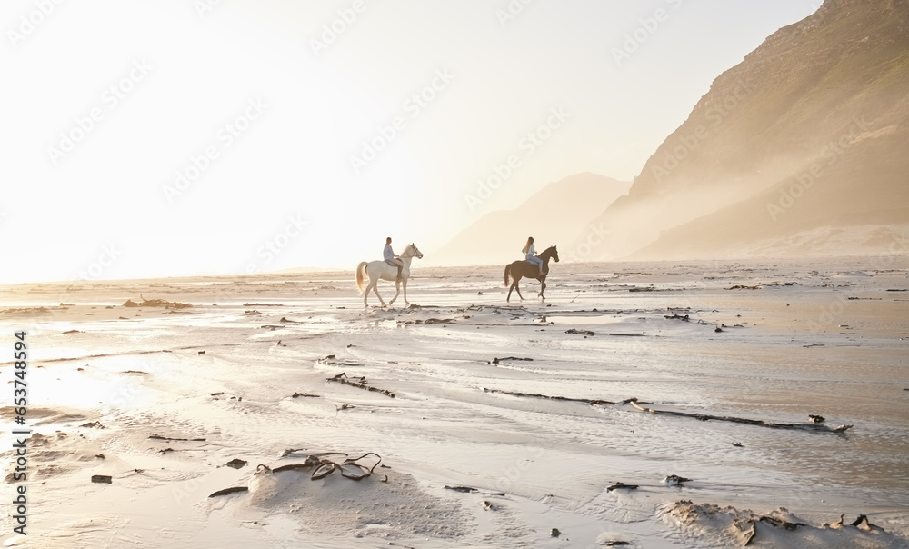 Woman, friends and horse riding for sport at beach with back view while traveling on vacation, trip or wellness. People, together and race for bond, self care and adventure on holiday with sunset