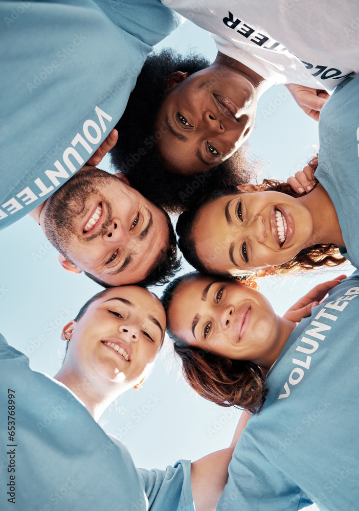 Huddle, faces and volunteer team from low angle together for charity donation as support, unity and teamwork. Diversity, group and people in collaboration at sustainability clean up on earth day