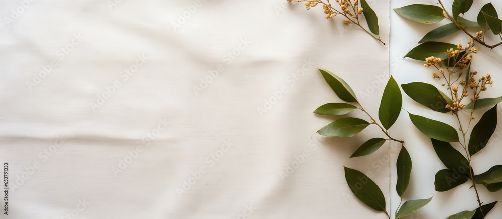 Autumn flat lay with dry green leaves on white linen fabric Minimalist mockup template