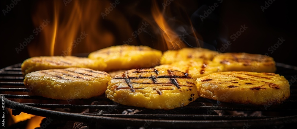 Yellow arepa grilling on a handmade stove with wood as fuel in Colombian coffee zone farm