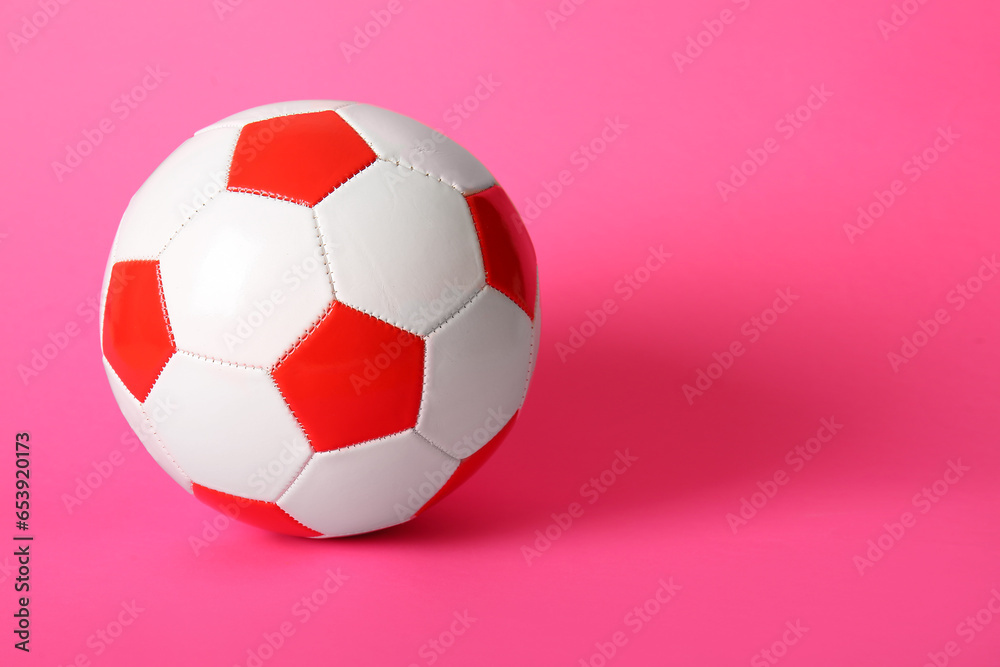 Soccer ball on pink background