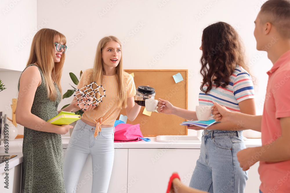 Group of students drinking coffee in kitchen