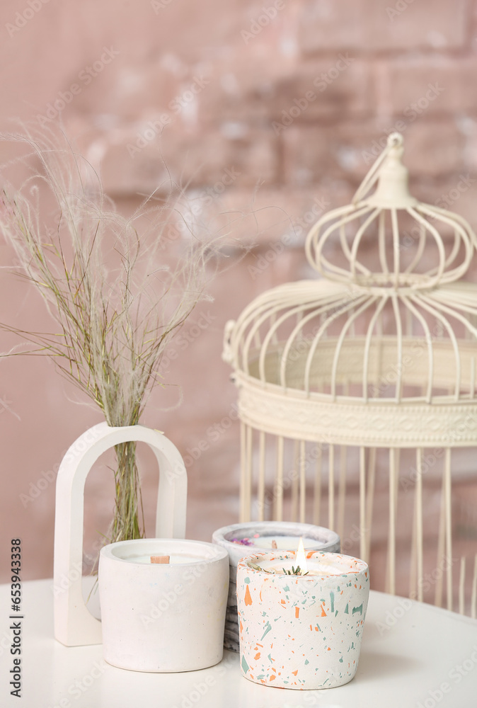 Holders with candles on table in room