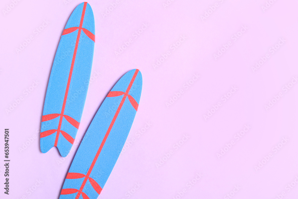 Mini surfboards on lilac background