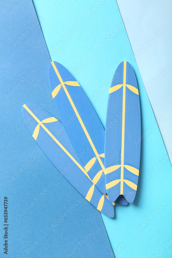 Mini surfboards on color background