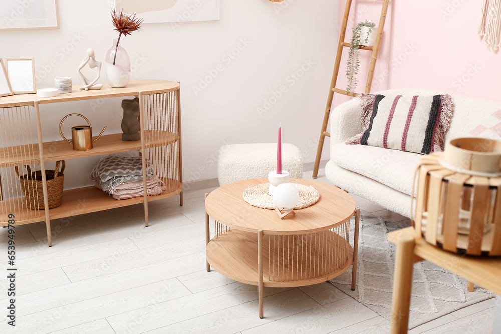 Living room interior with white sofa, coffee table and shelving unit