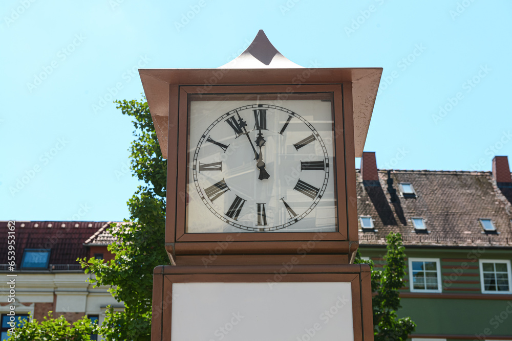 Old clock on city street, closeup