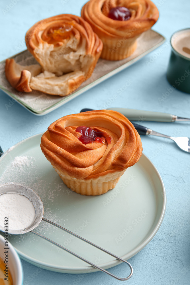 Plates of tasty cruffins with jam on white background