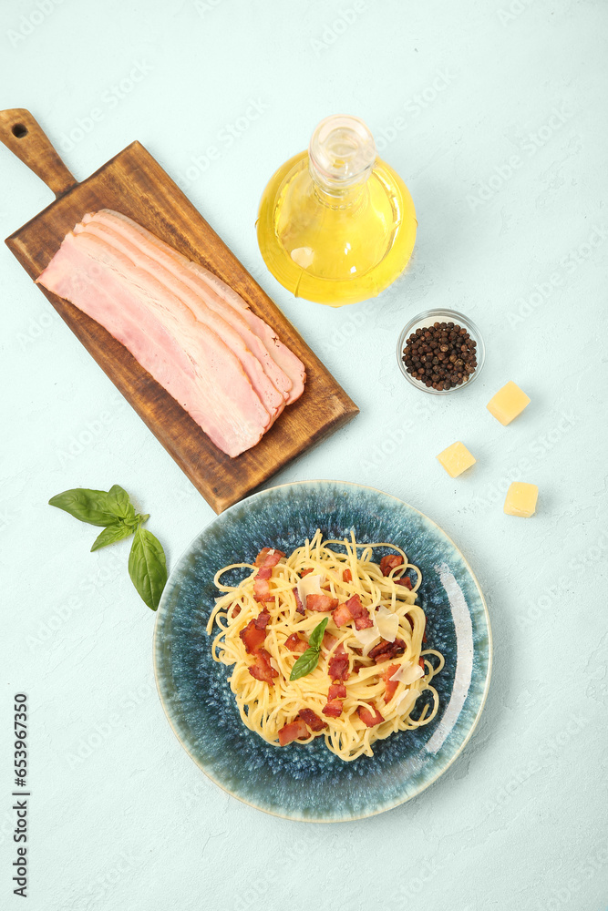 Plate with tasty pasta carbonara and ingredients on white background