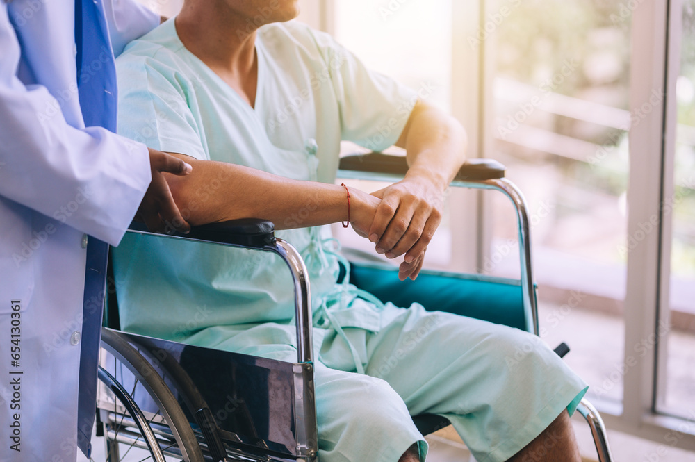 Close-up of the hands of a patient sitting in a wheelchair in the hospital