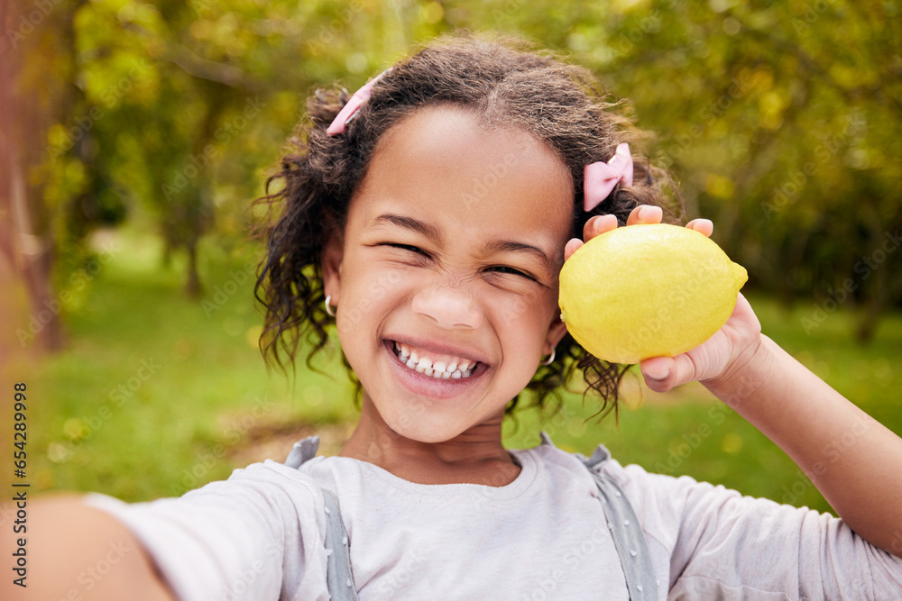 Selfie, portrait and girl child with fruit and smile in nature for wellness, nutrition and healthy lifestyle. Face, kid and person with lemon in hand for summer, eating and happiness outdoor on farm