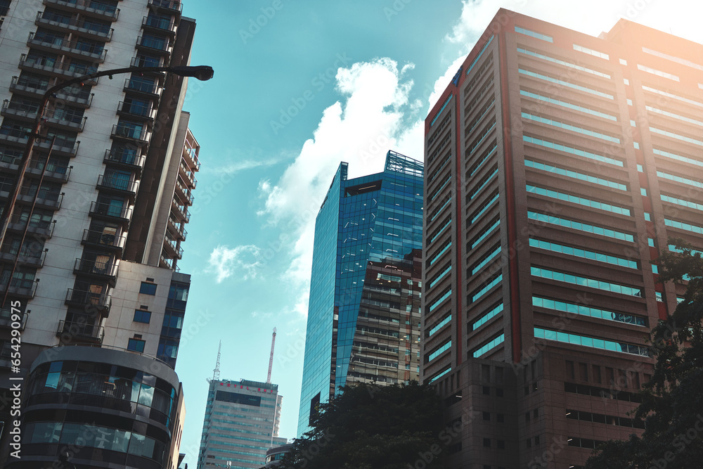 City, buildings and infrastructure with landscape for urban skyscraper or architecture outdoor with clouds. Development, town and skyline with cityscape, tower and hotel with modern exterior or roof