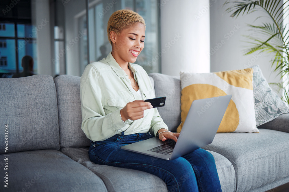 Woman, laptop and credit card for home online shopping, fintech payment and e commerce on her sofa. African person on computer for internet banking, website subscription or application for loan