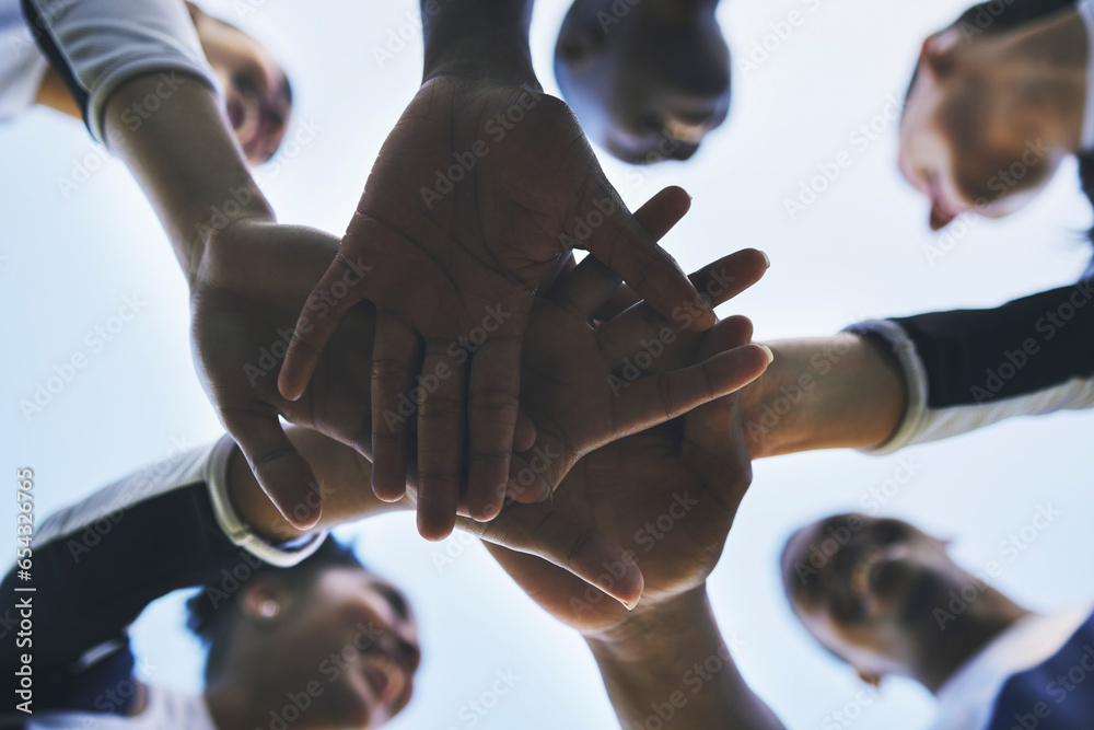 Cheerleader, hands or people in huddle for motivation with support, hope or goal in game on field. Teamwork, low angle or group of sports athletes cheerleaders with pride, plan or solidarity together