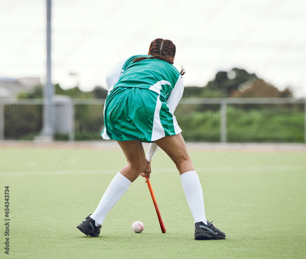 Hockey, athlete and woman running in game, tournament or competition with ball and stick on grass. Sports, back of player and action play in training, exercise or workout with gear on field ground