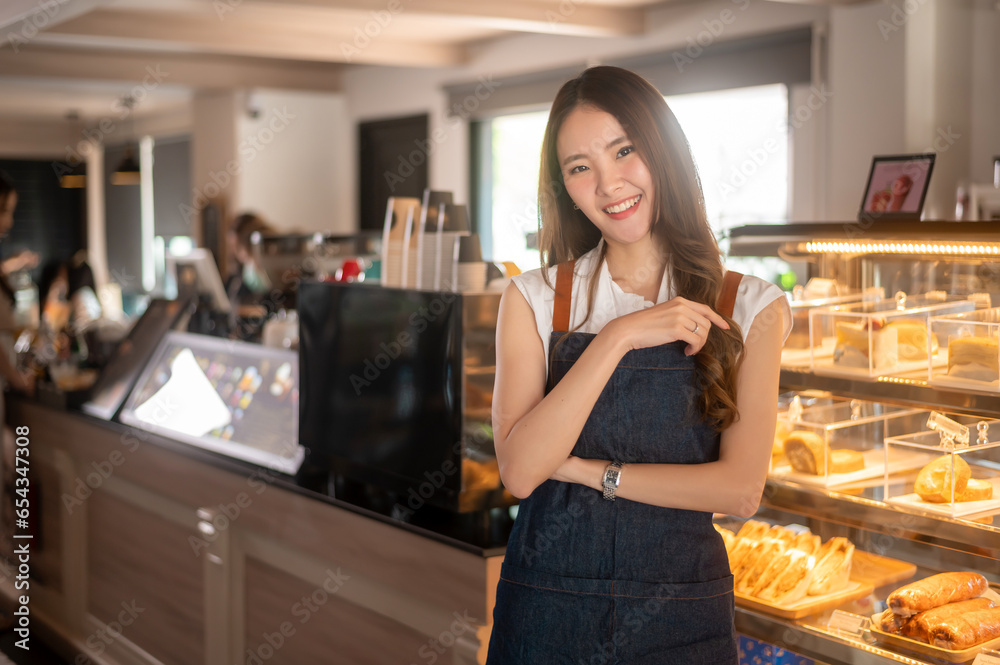 An Asian woman entrepreneur or barista working in modern coffee shop , concept small business