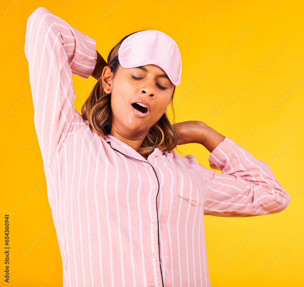 Woman, pajamas and yawn with stretch in studio for sleep or peaceful for stress, tired or sad for burnout. Female model, eye mask and relax for dream or wake up for insomnia, headache or self care