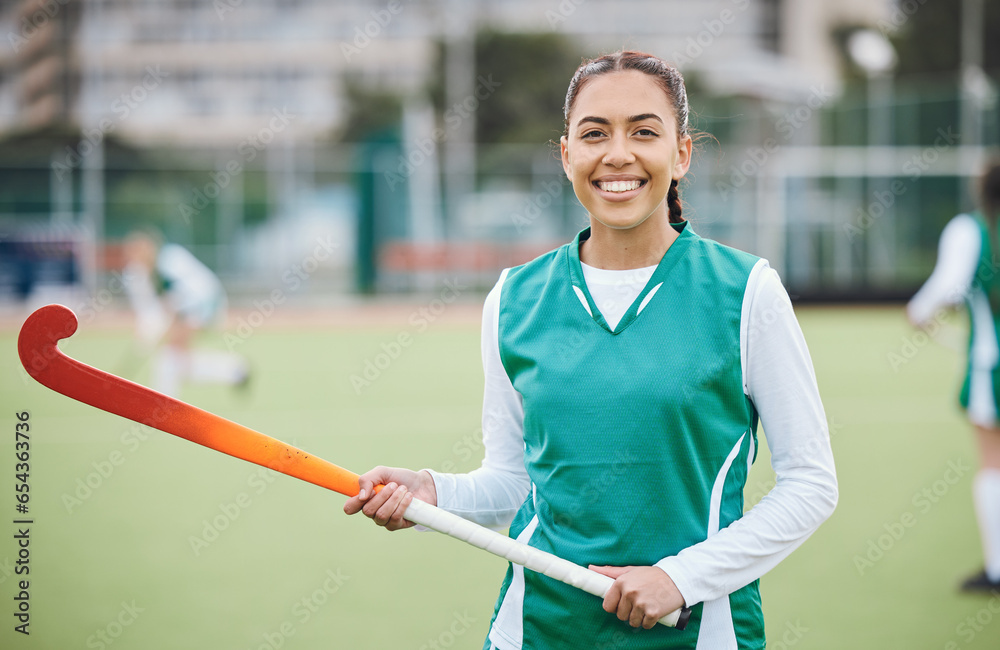 Female, person and happy for hockey with stick in hand on field for training in portrait. Girl, hold and smile with confidence for sports with pose, stand and equipment for match, game or fitness