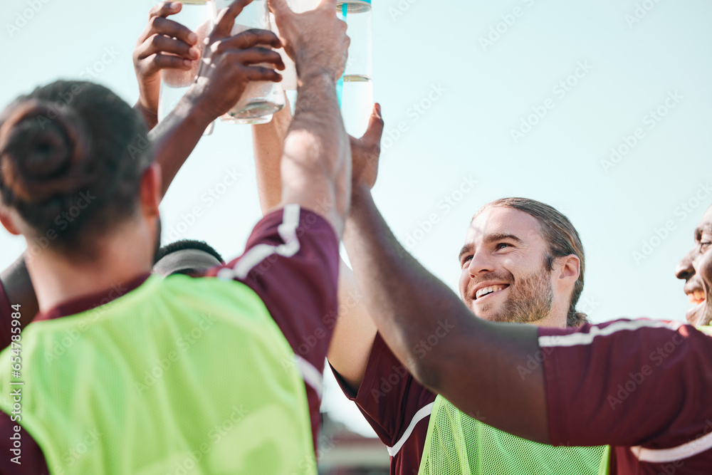 Soccer team, water bottle and exercise cheers with teamwork, achievement and community on grass field. Fitness, workout and sport training of men group with smile and celebration from game with drink