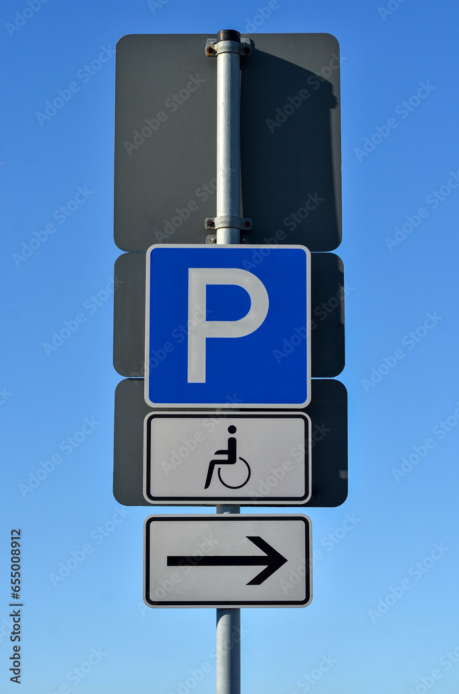 Disabled parking signs in city, closeup